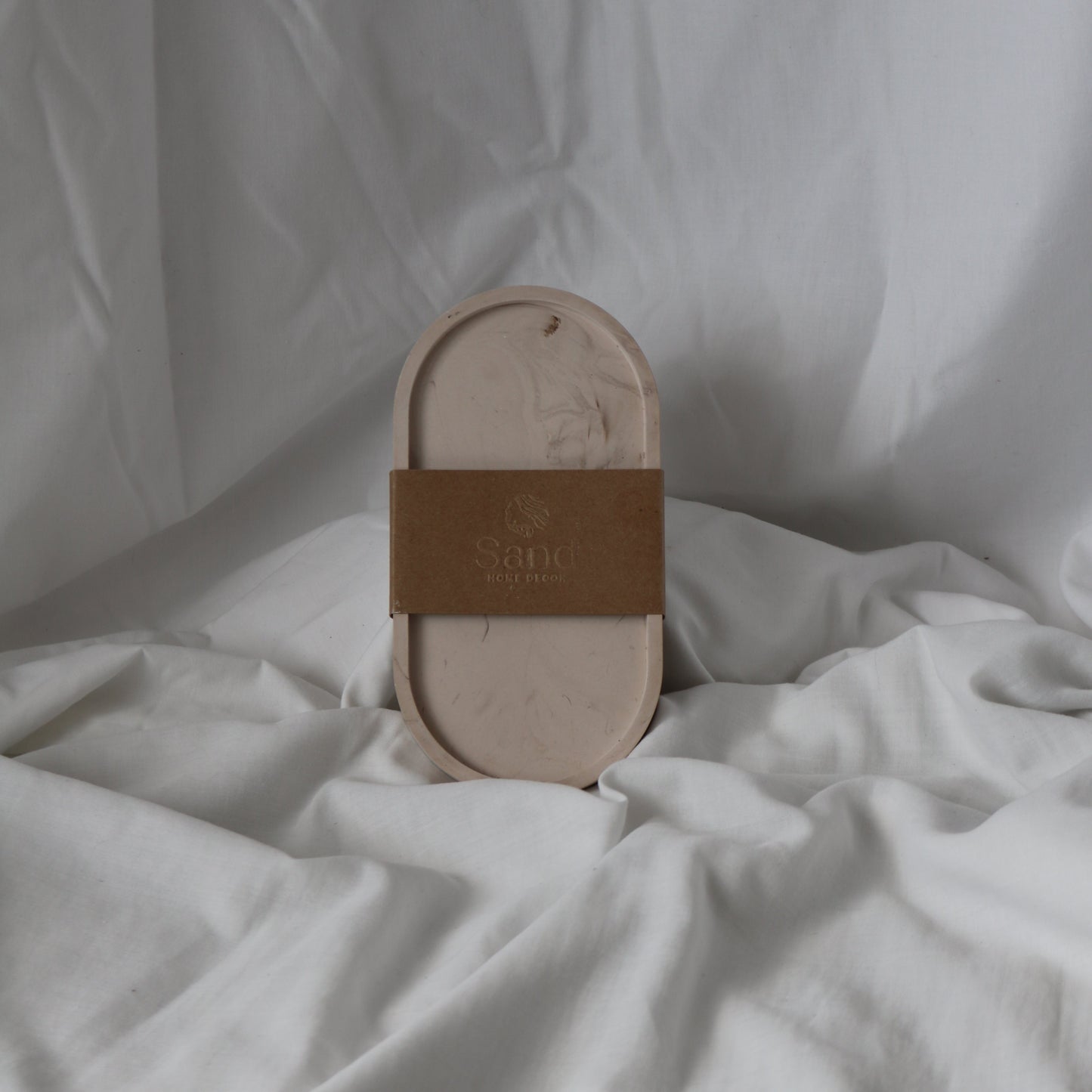 Handmade trinket tray with branded kraft paper label.
