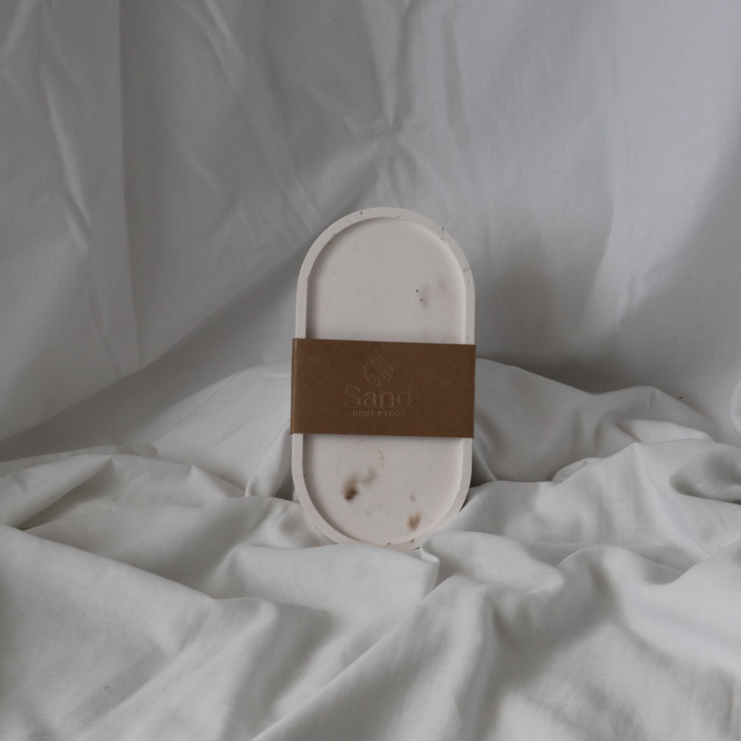 Handmade trinket tray with branded kraft paper label.