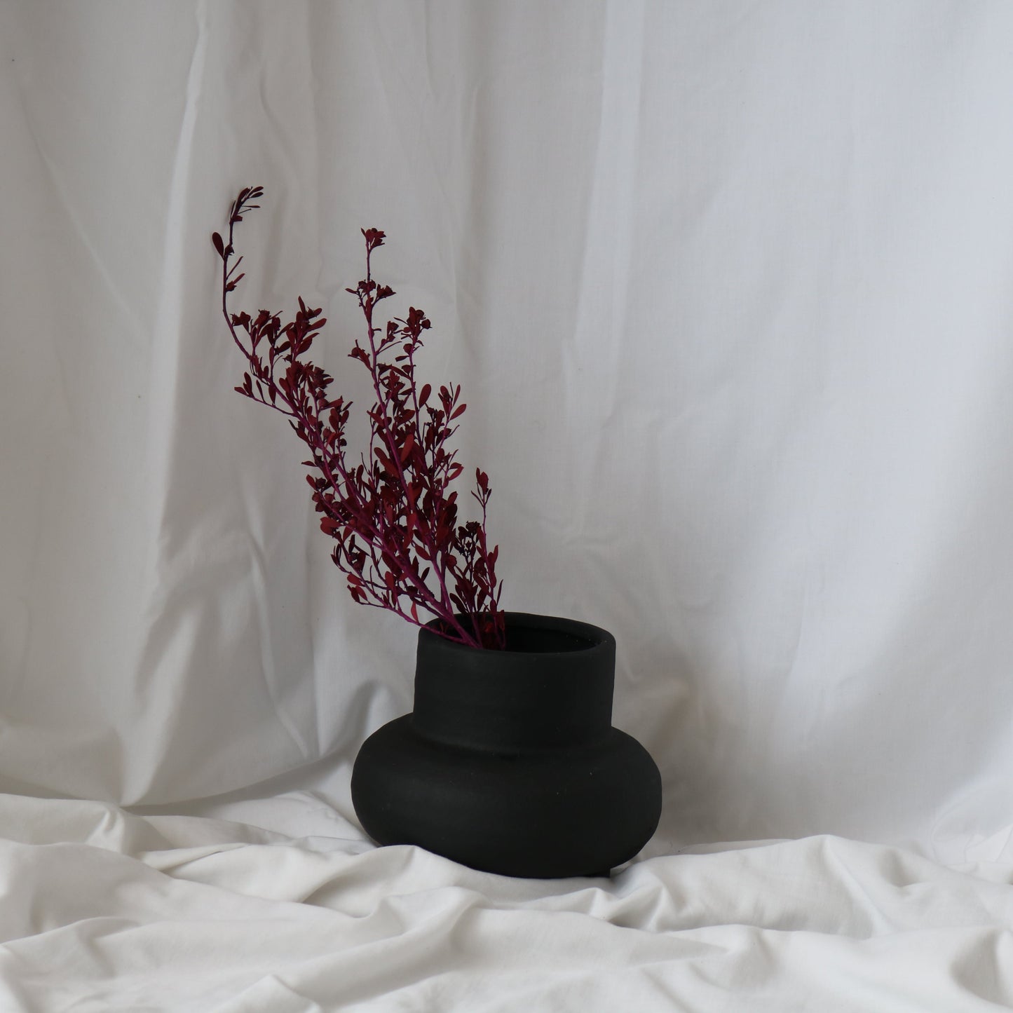 ceramic black vase styled with dried flowers. Perfect for styling.