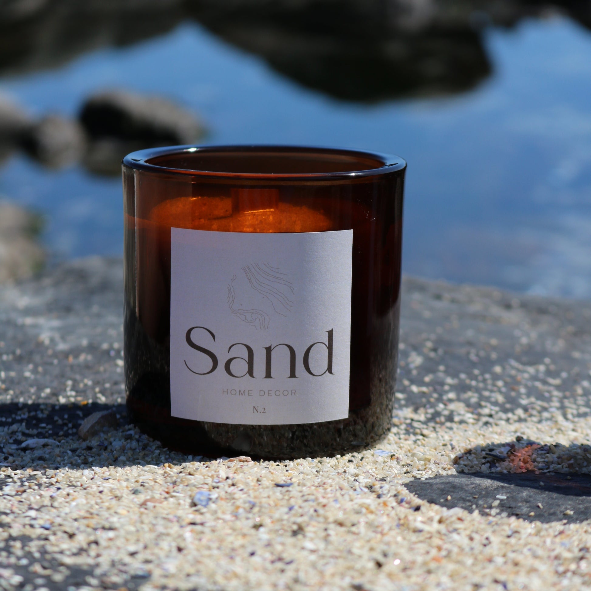 Beautiful handmade scented soy candle in a large amber glass jar with a wooden wick. 