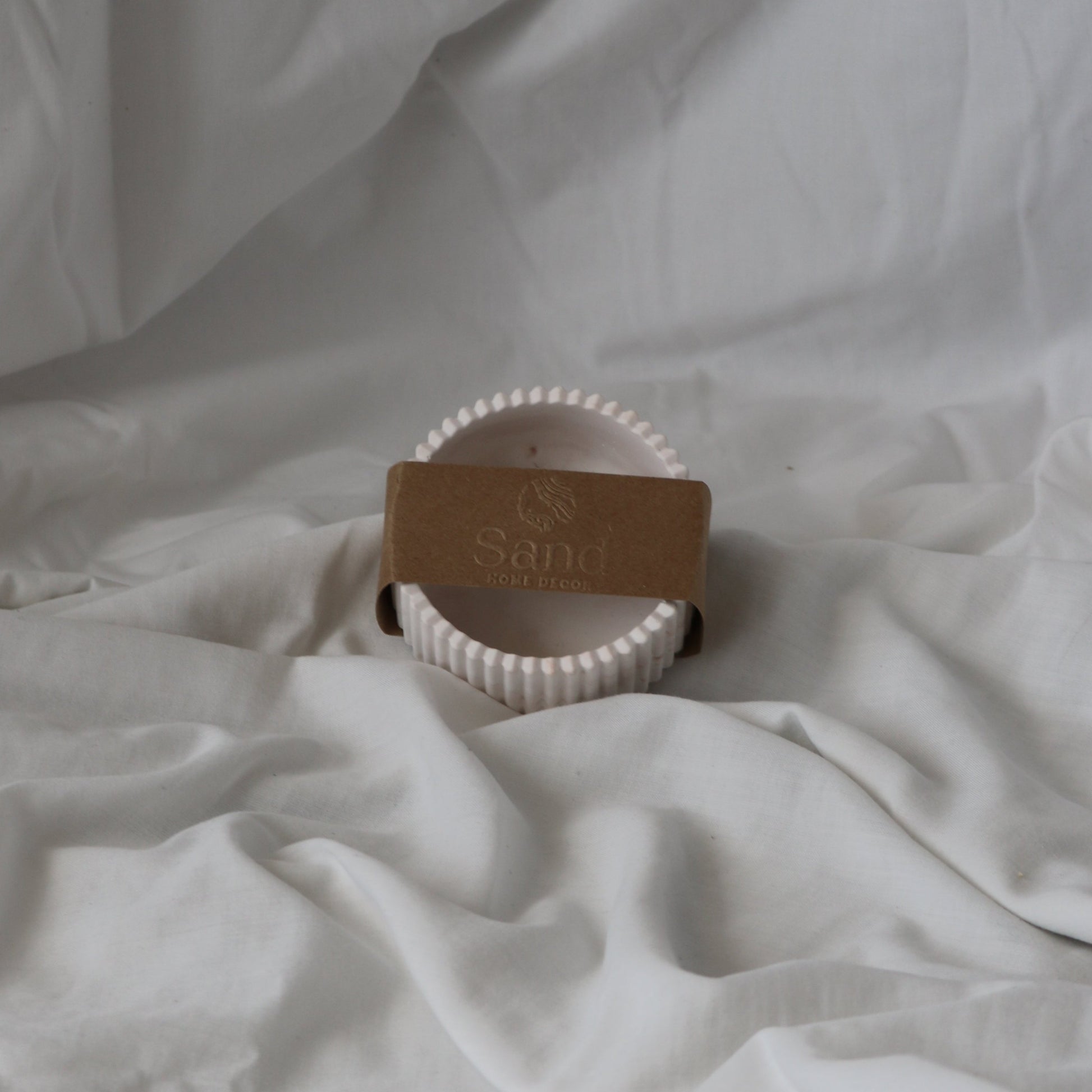 Handmade ribbed trinket dish with branded kraft paper label. 