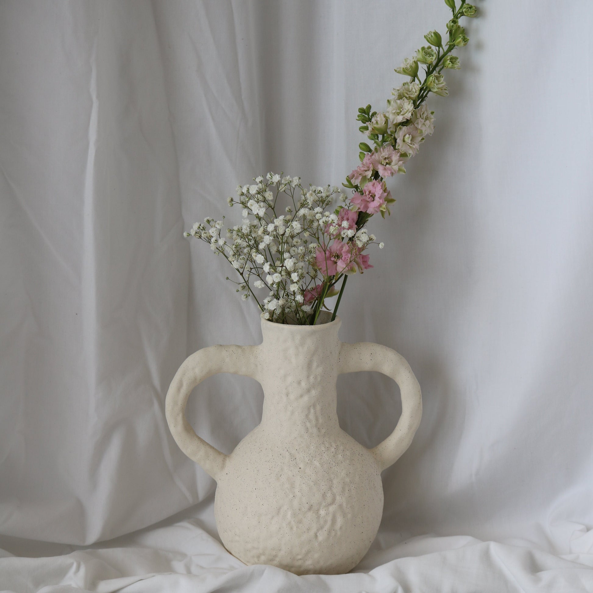 Beautiful large textured white vase with flowers. Perfect for home decor styling.