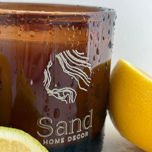 Brown decorative container with 'Sand Home Decor' branding next to a lemon on a white background