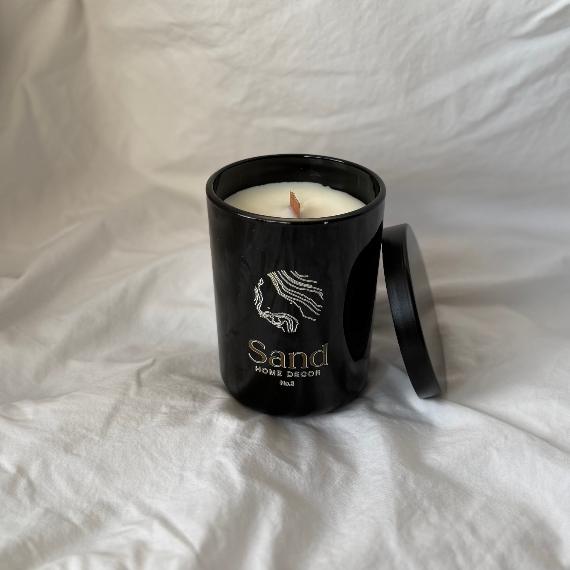 white background with black gloss soy candle and lid 