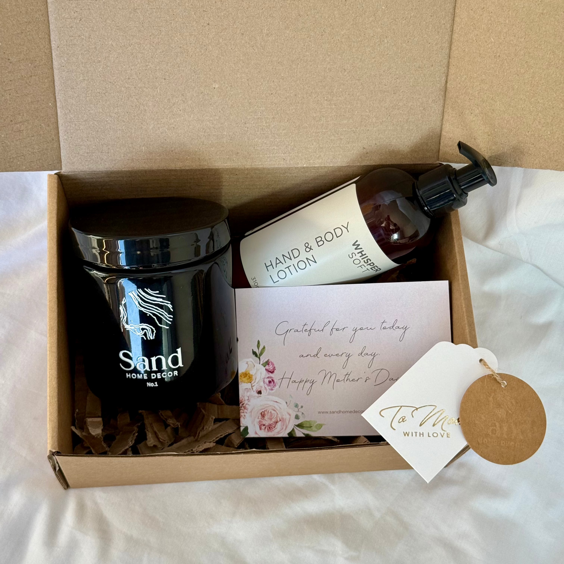 mothers day gift box with a handmade soy candle and hand and body lotion and a note to moms 