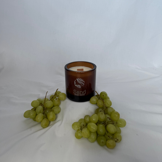 Candle with grapes on a white background
